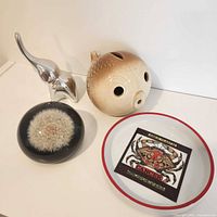 All four items grouped: Hoselton elephant, puffer fish bank, dandelion paperweight, Cancer dish