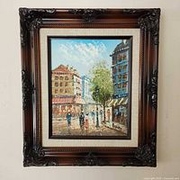 Framed oil painting hung on wall