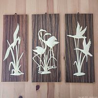 Front view of all three plaques showing designs