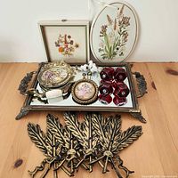 Full lot overview showing tray, knobs, plaques, prints, swag