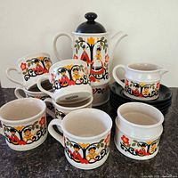 Full set showing teapot, cups, saucers, sugar bowl and creamer