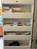 Overall view of cabinet shelves with boxed dressings and bandages