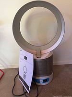 Front view showing circular loop, perforated base, power cord, instruction sheet