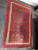 Full view of rug showing design, colors and borders