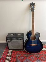 Ibanez guitar beside Fender Sidekick Reverb 25 amp