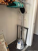 Steamer, drying rack and some hangers in closet