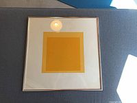 Front view of framed lithograph showing image area and mat