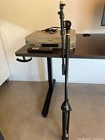 VCR on desk with stand folded alongside