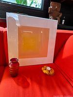 All three items together: framed artwork, glass vase, tealight holder