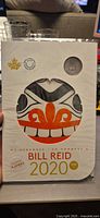Front view of sealed Bill Reid keepsake folder showing Haida artwork and mint logos