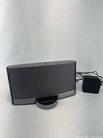 Front view of Bose dock speaker with AC adapter