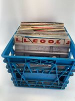 Front view of blue crate filled with vinyl records; LL Cool J sleeve visible