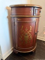 Front and side view of demilune cabinet showing painted motif and hardware