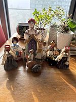 Group shot of all nine dolls and two eggs on tabletop