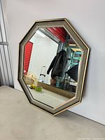 full view of octagon wall mirror standing against wall