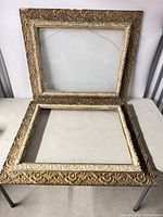 Both frames displayed, one upright showing glass, one flat showing open center