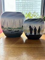 Both vases front view showing painted landscape and silhouette motifs