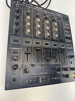 Top view of Pioneer DJM-500 mixer showing full control layout and cosmetic wear