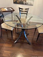 Round glass table with four chairs overview