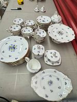 Full set arranged on table showing plates, cups, saucers, serving pieces