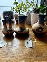 Front view of all three signed Navajo miniature vases with tags visible