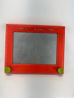 Front view of Etch A Sketch showing full frame, knobs, and screen