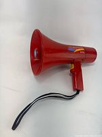 Full view of red handheld megaphone with strap