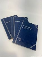 Three blue Whitman coin folders labeled Cents, Nickels, Canadian Nickel Collection 1922 to 1960