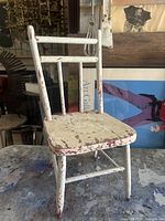 Front view of distressed painted child’s chair