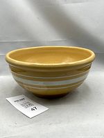 Side view of yellowware bowl showing white bands and overall form