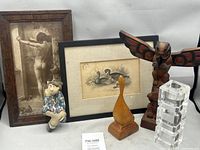 Group shot of all six items including framed prints, sculptures, candle holder