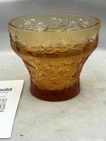 Front angled view of amber Lalique Coriandre bowl