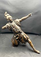 Front three-quarter view of samurai archer showing dynamic pose and bronze patina
