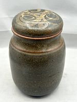 Full view of stoneware jar with lid