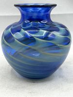 Front view of cobalt blue vase displaying swirled pattern