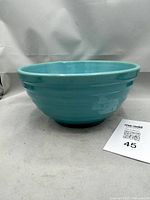 Angled view of turquoise ribbed mixing bowl