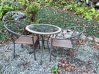 Table and both chairs on gravel patio