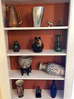 Full bookcase view showing all thirteen items arranged on shelves