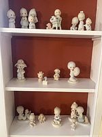 Full view of three shelves showing all 17 figurines