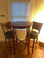 Table with two matching bar stools in room