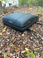 Closed Thule Weekender cargo box resting on ground, top view