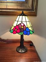 Front view of lamp illuminated showing stained glass pattern