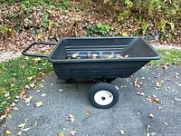 Side view of black poly tub cart on white-rim pneumatic wheels