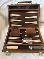 Open case showing board, dice cups, checkers, dice, doubling cube