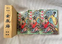 Three illustrated paperback volumes with slipcase shown