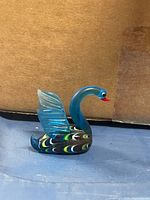 Left profile of blue glass swan figurine