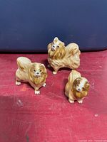 three matching ceramic dog figurines