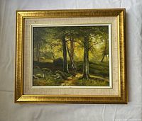 Front of framed forest landscape painting
