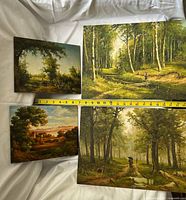 Group shot of four landscape paintings with tape measure