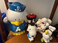 Group view of all five piggy banks on shelf